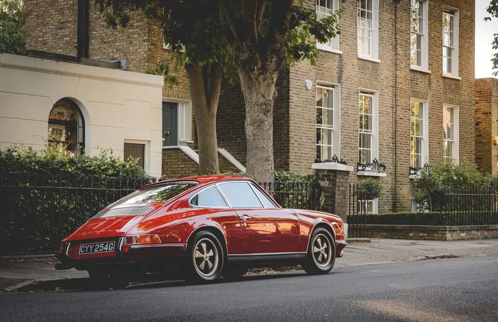 Suttons-Knight-Frank-Luxury-Index-2025-banner classic car Red Porsche 911 parked on a street