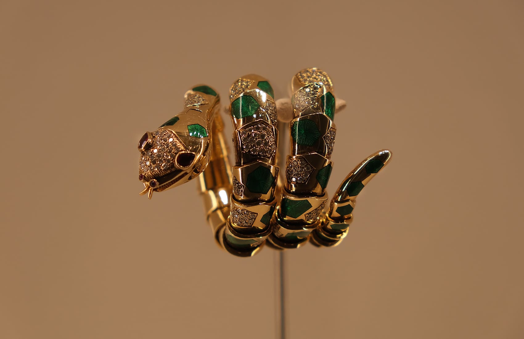 Suttons and Robertsons Serpenti Bracelet feature image BVLGARI Serpenti bracelet watch in gold with green enamel, rubies and diamonds.