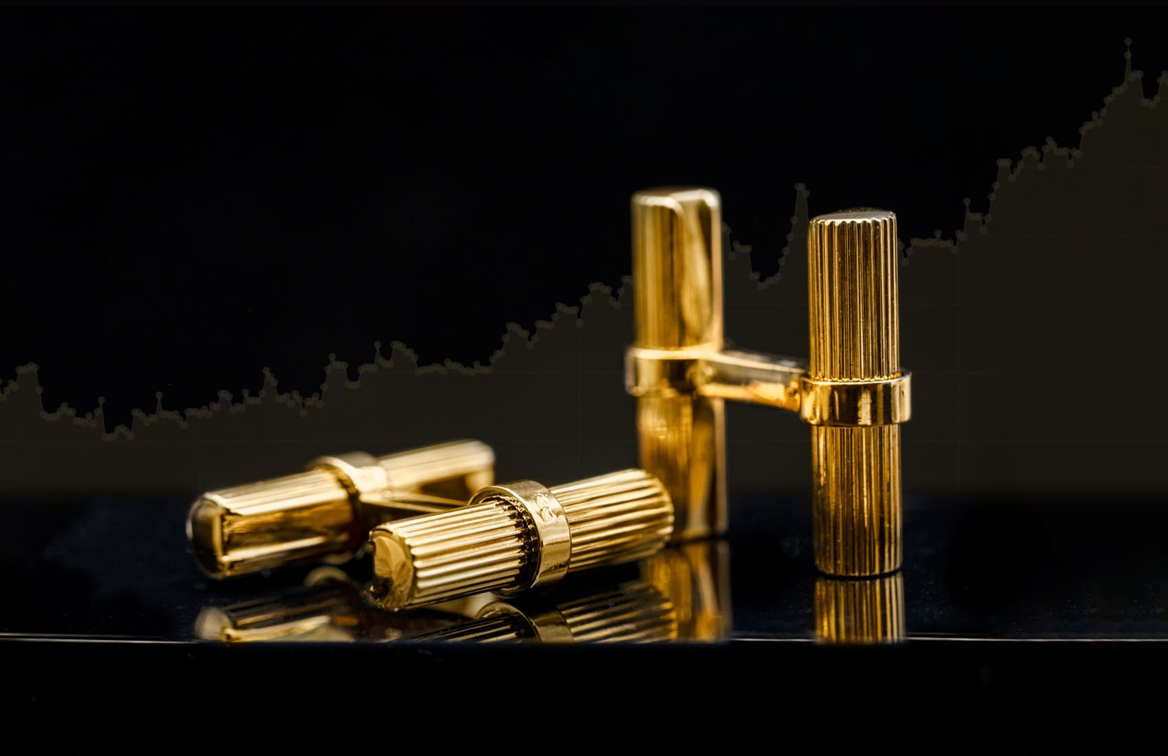 Suttons Is Now A Good Time To Sell Gold FEB 2025 Banner 18K yellow gold cufflinks with gold value chart background